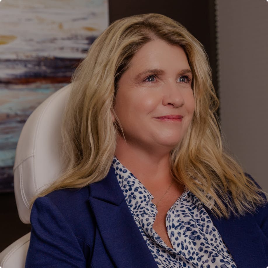 Smiling patient in an exam chair.