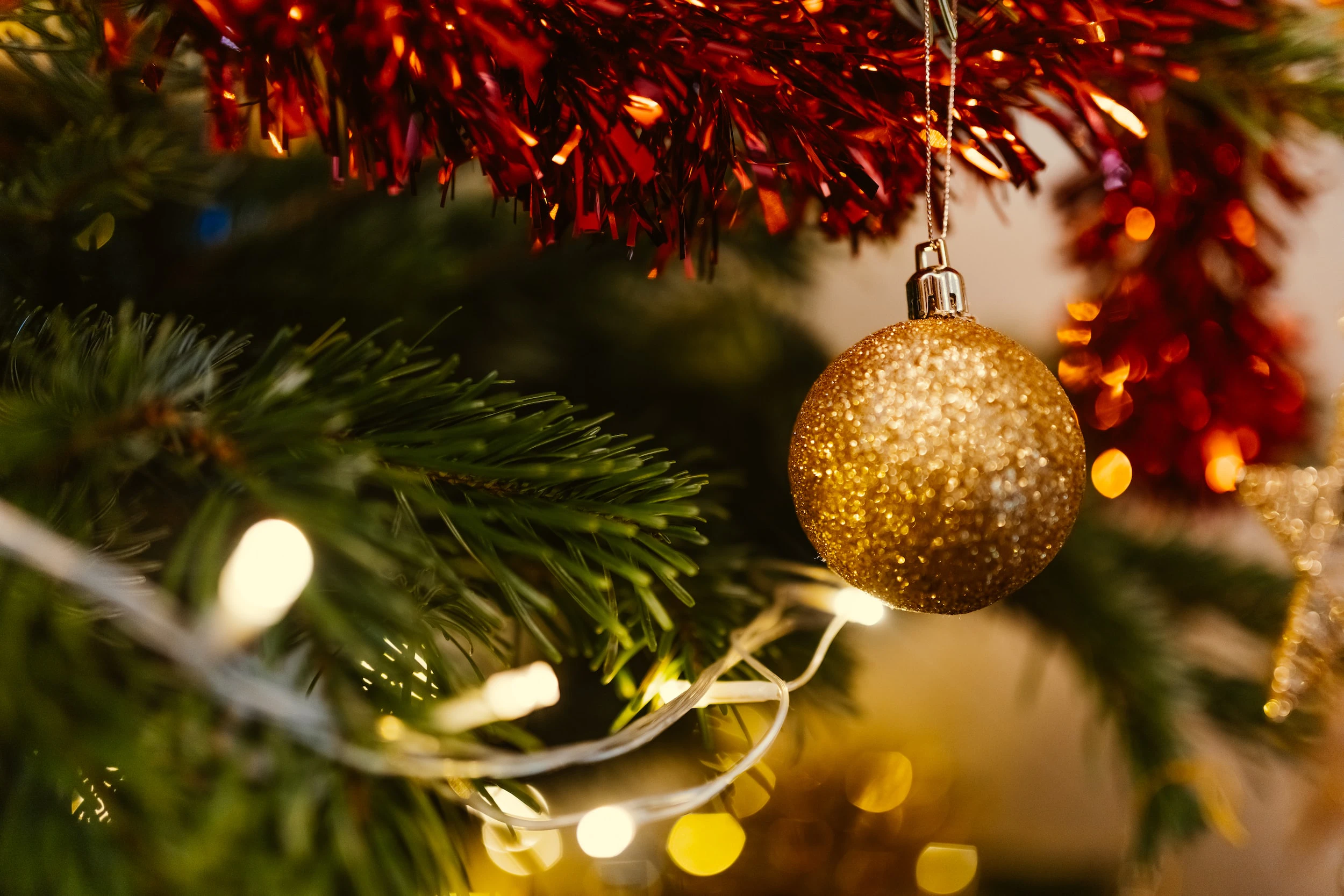 closeup photo of gold glittered Christmas bauble