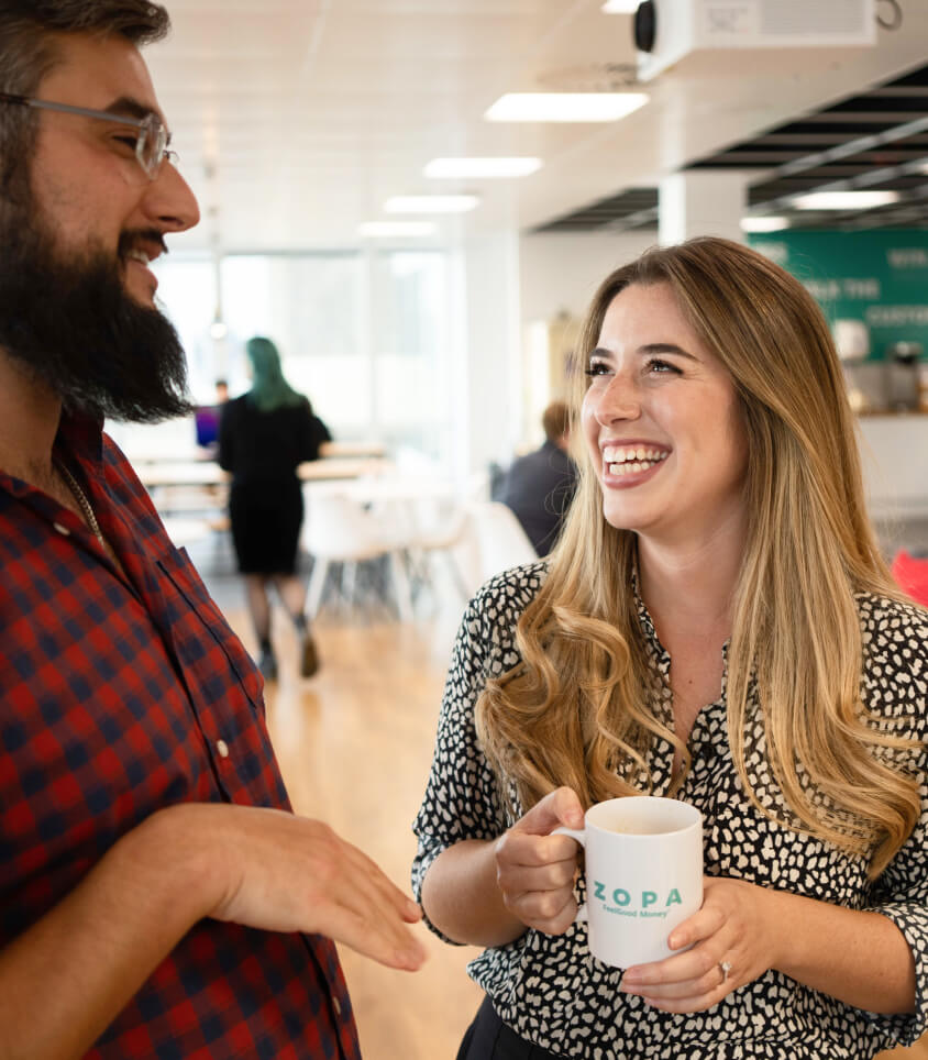 A man and a woman laughing together in the office