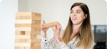 A woman playing giant Jenga