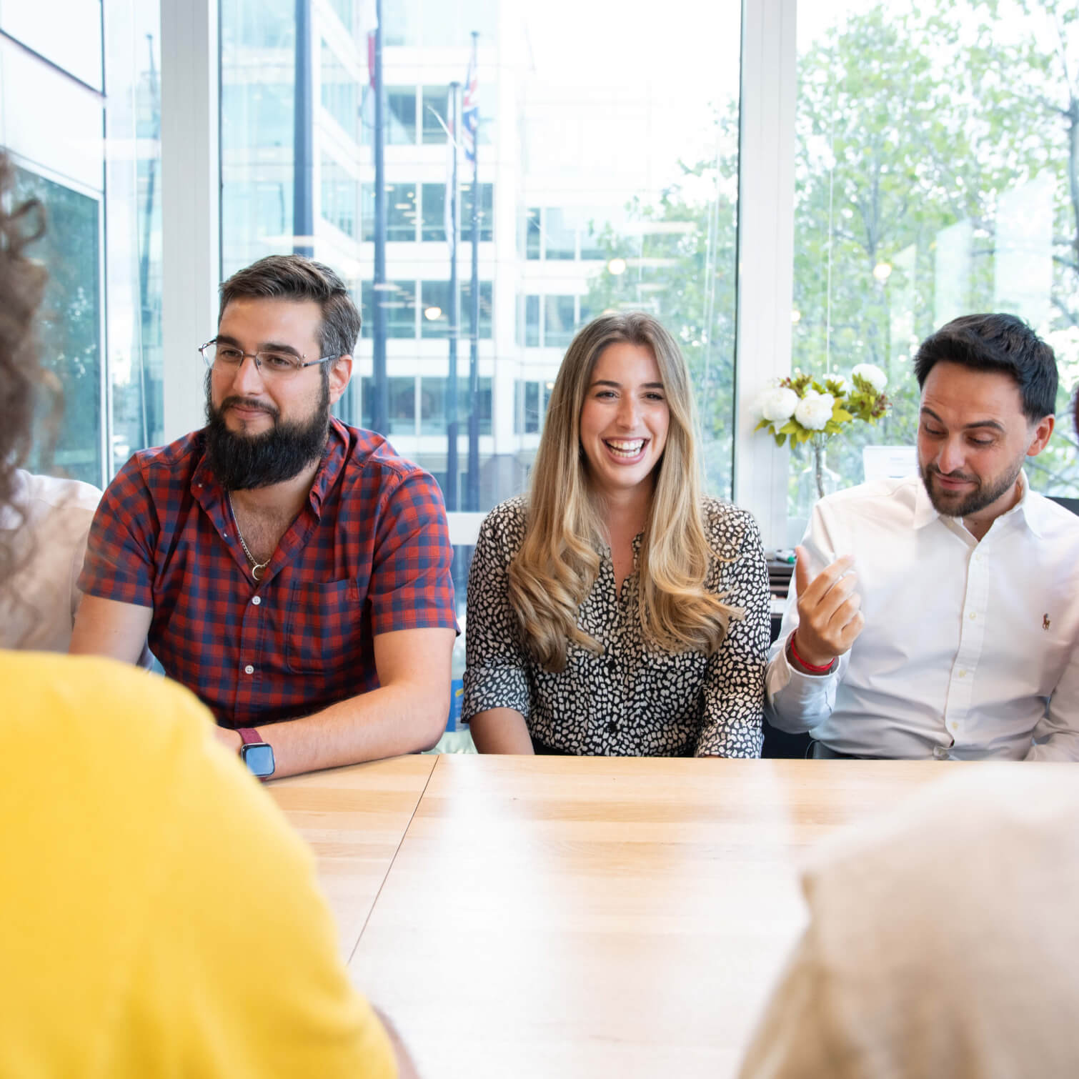 Employees sitting around a table