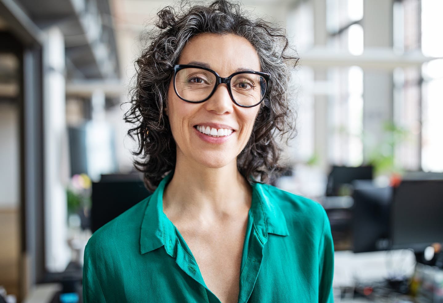 Woman with glasses and a green shirt