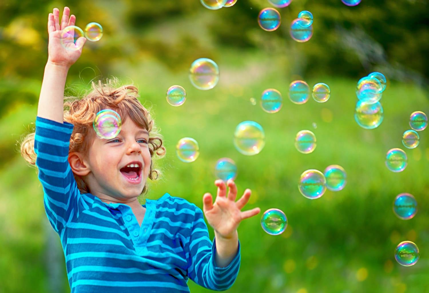 Kid playing with bubbles