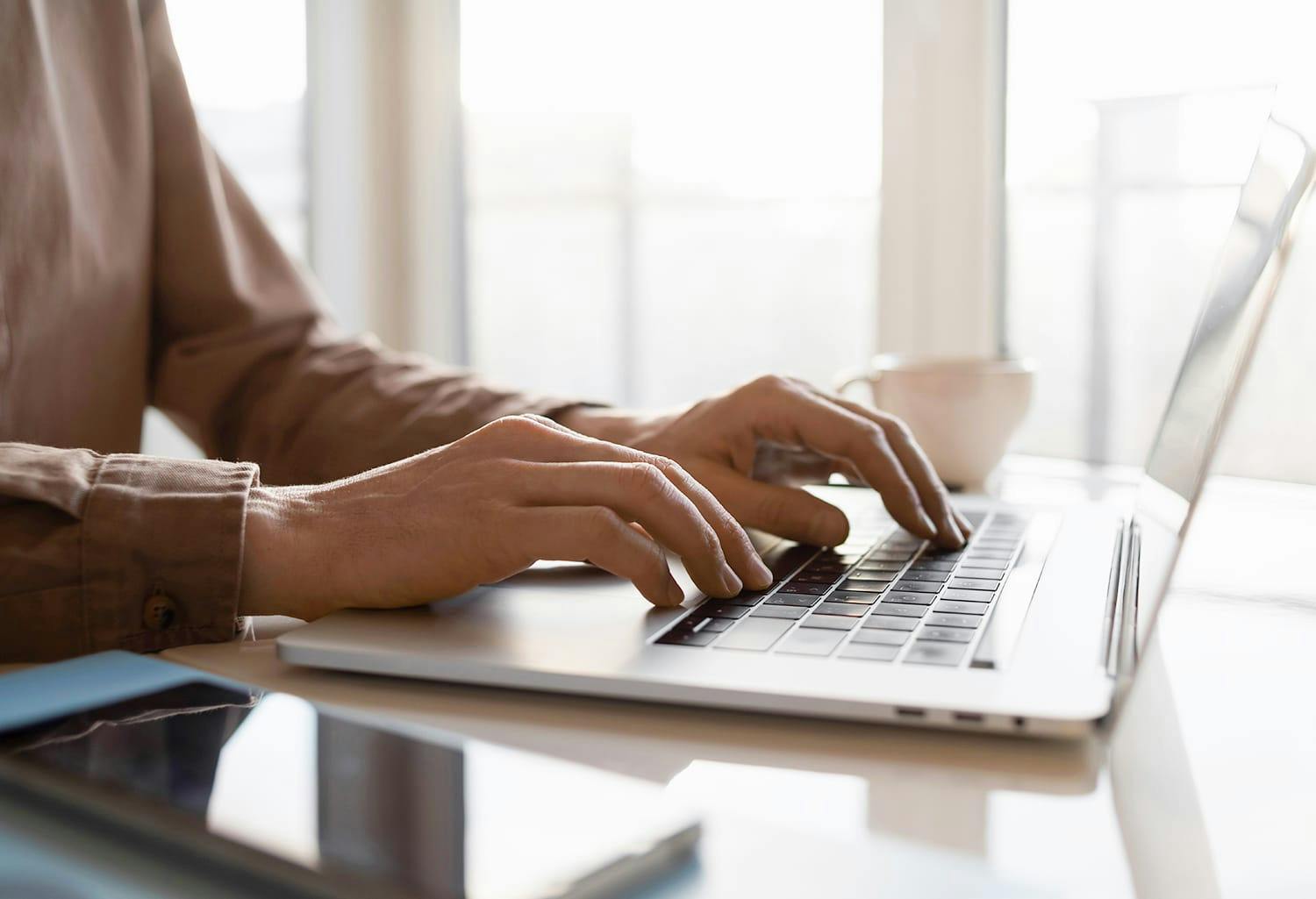 Hands on a laptop keyboard