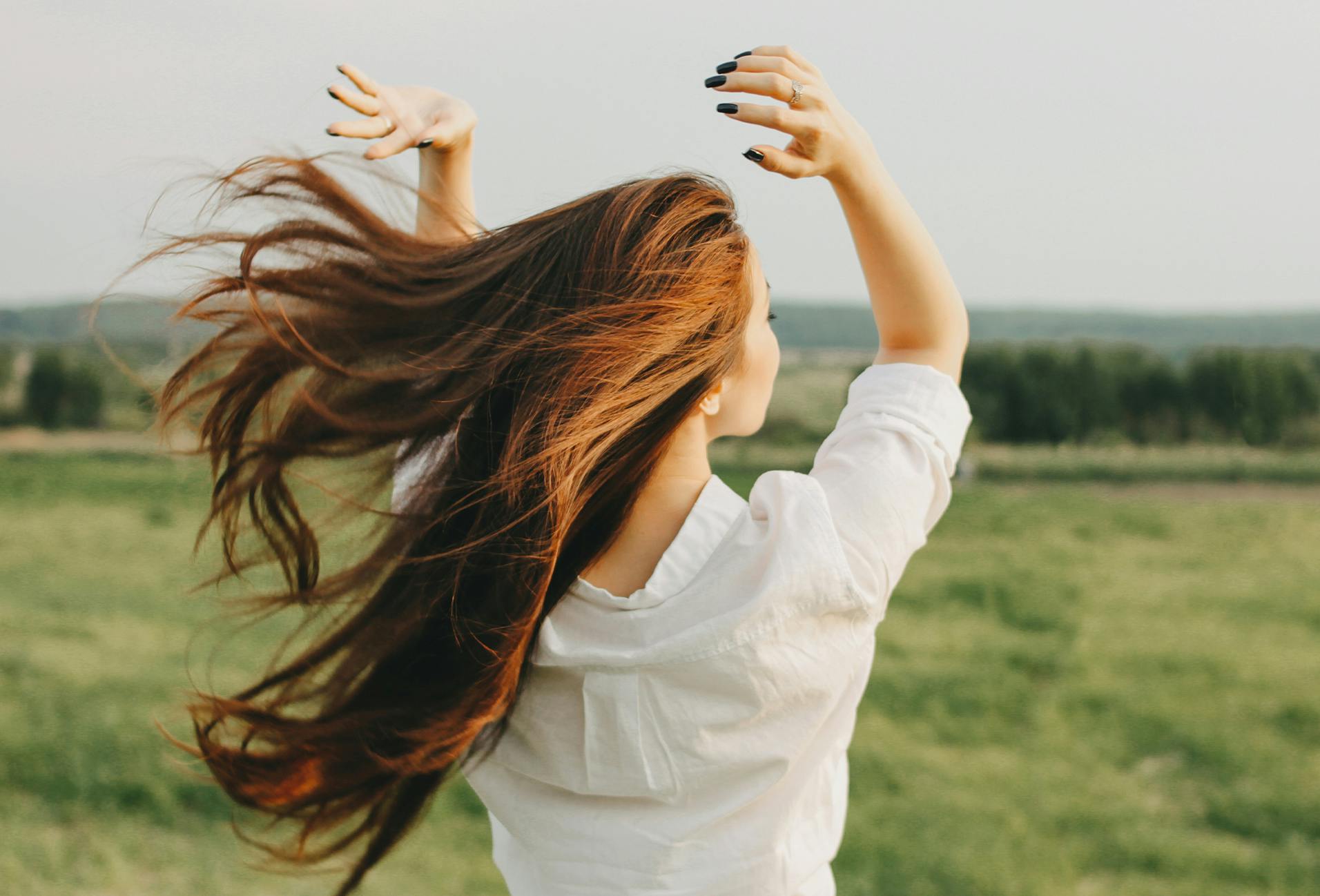 woman with long red hair outside