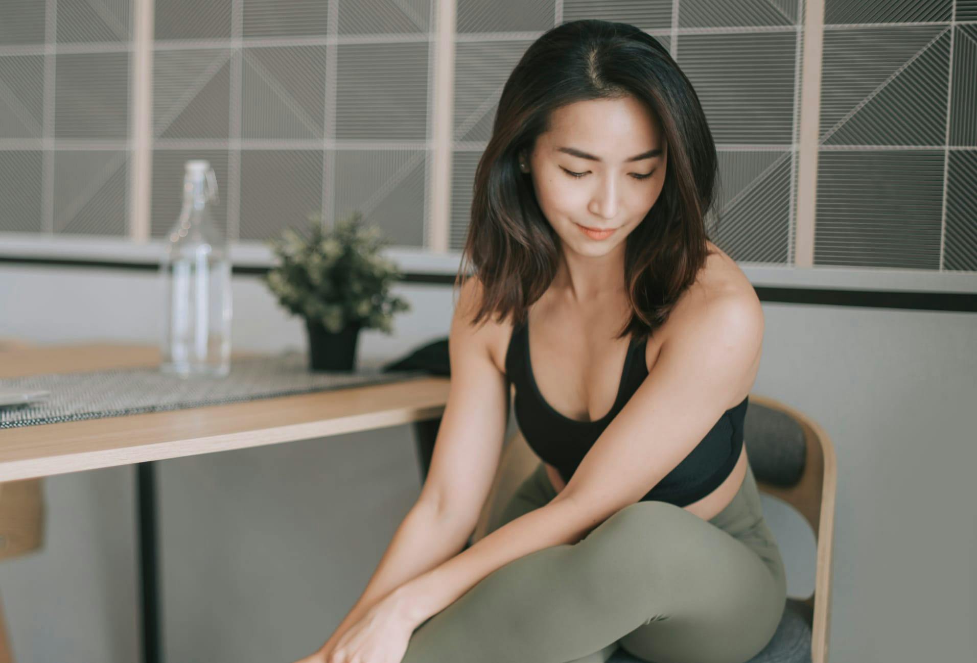 woman sitting down wearing athlesiure