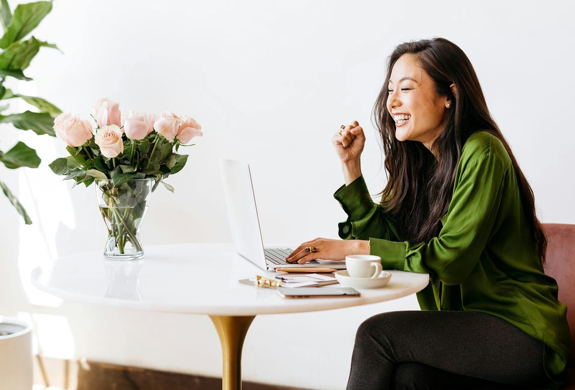 woman sitting at a table on a laptop