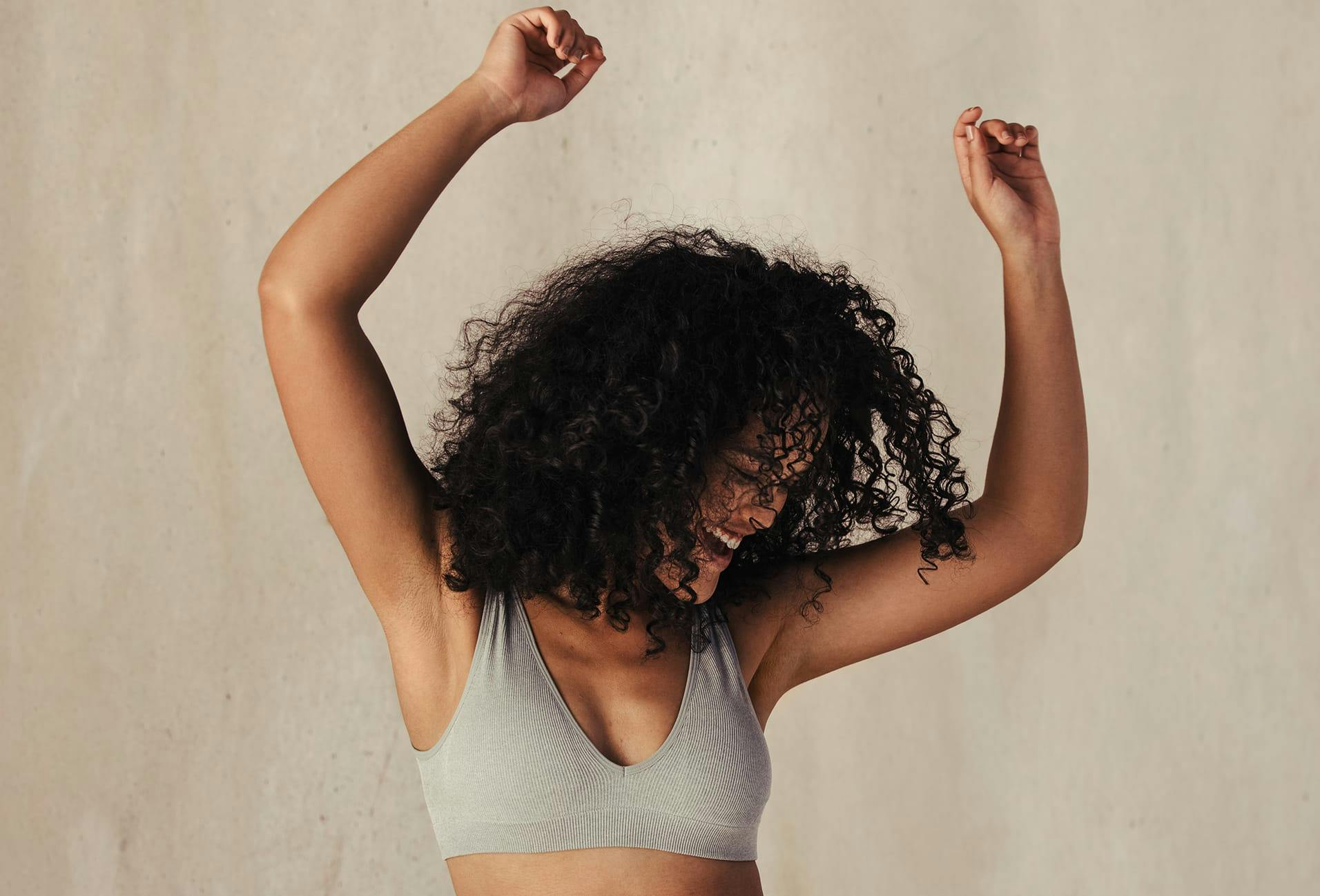 woman with her arms raised above her head