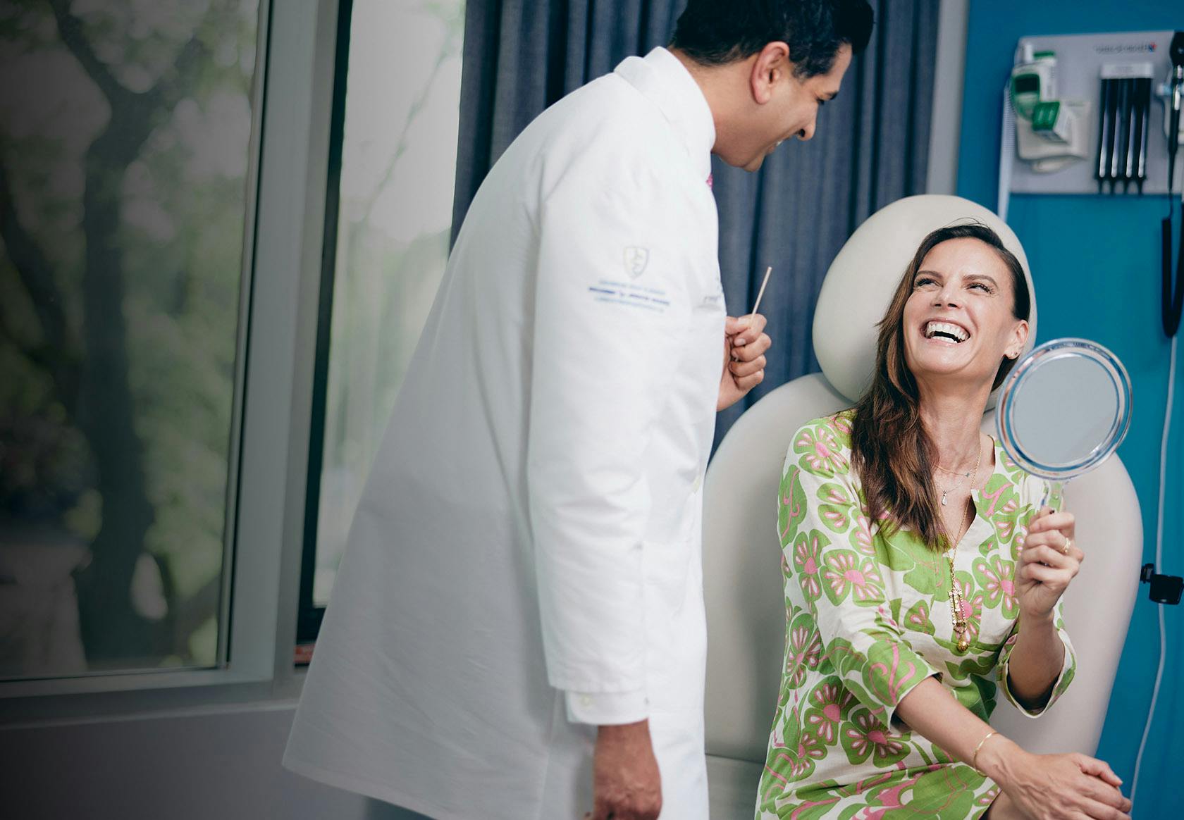 Dr. Tanna Laughing with a Patient