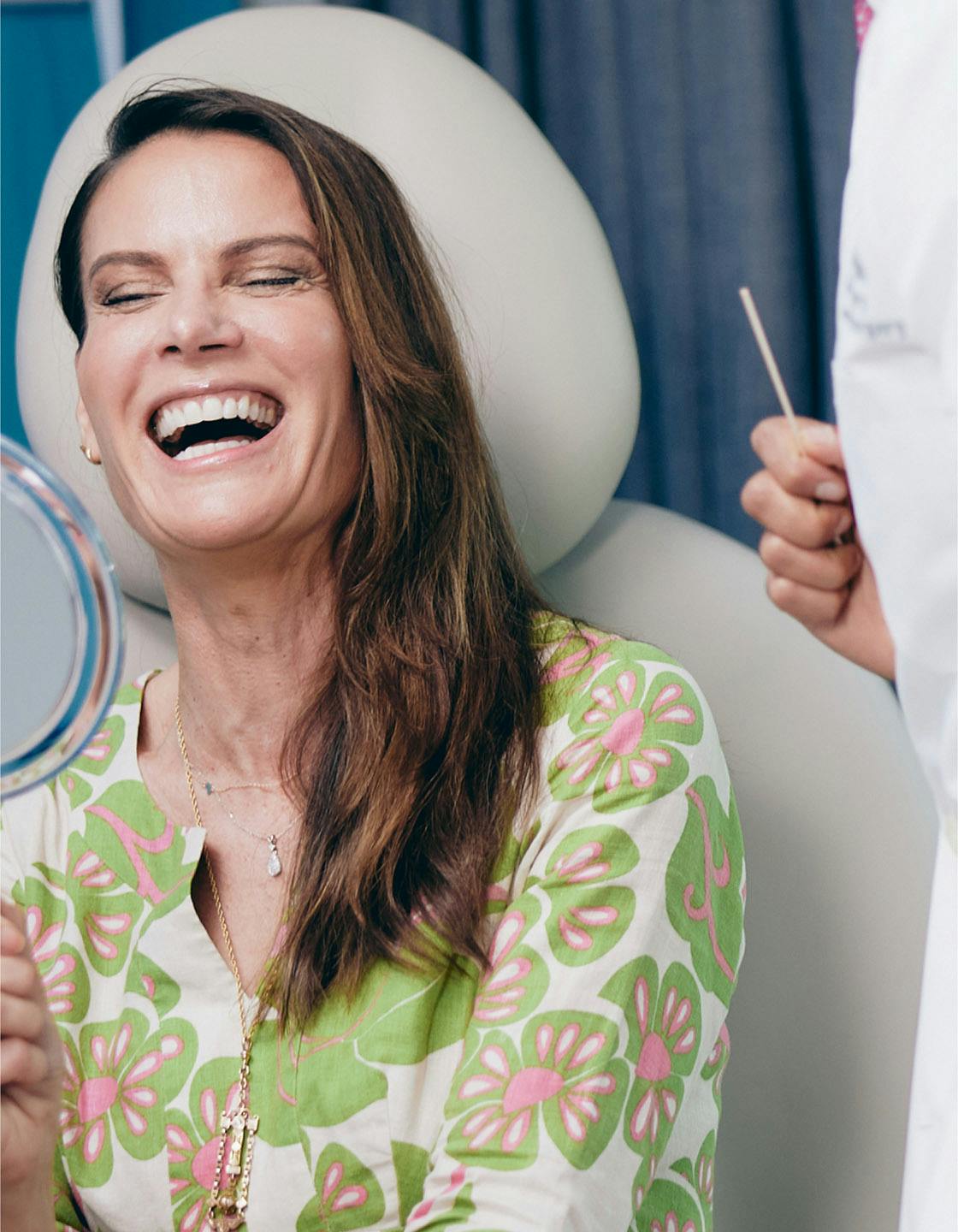 Woman smiling while looking at herself in the mirror
