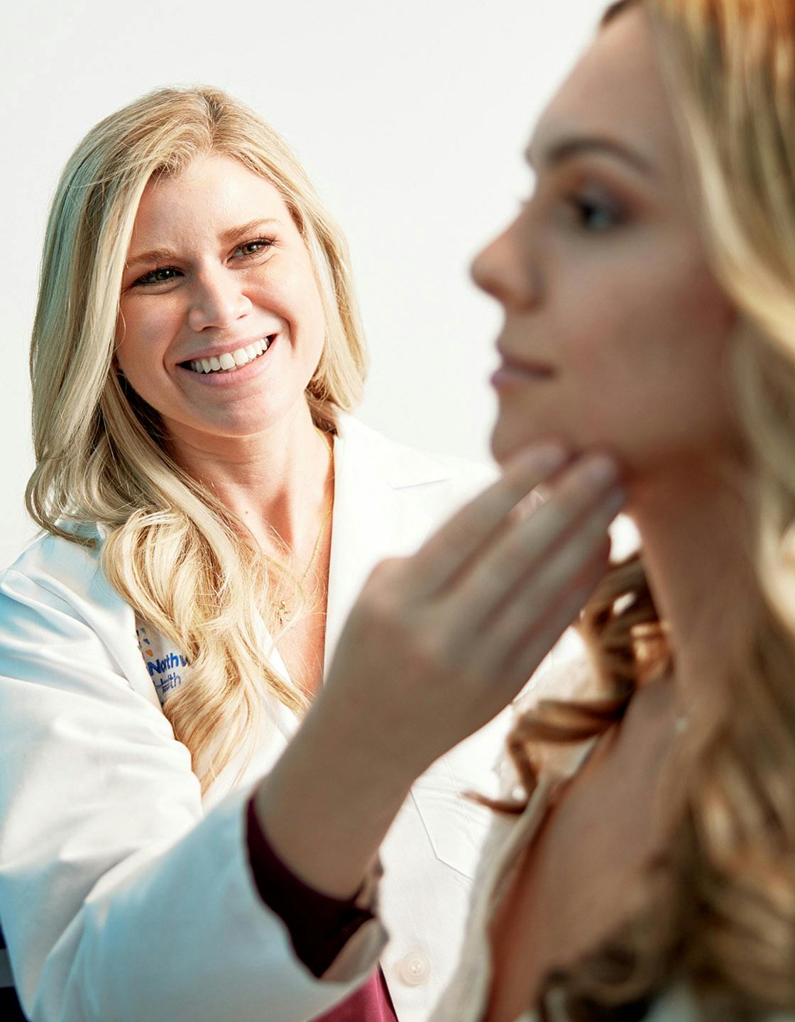 Doctor looking at a female patient's face