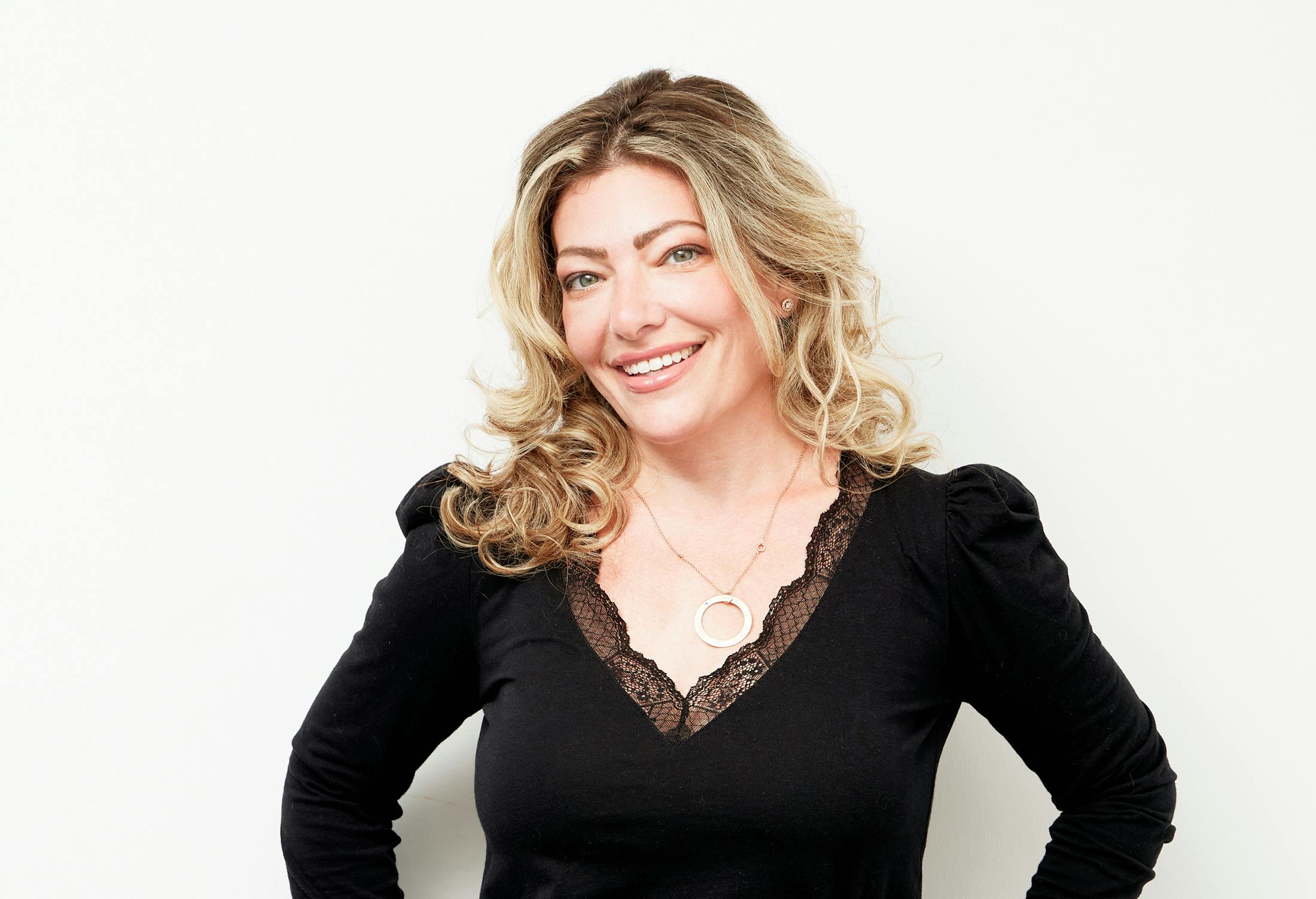 Smiling Woman with Blonde Hair and Black Shirt