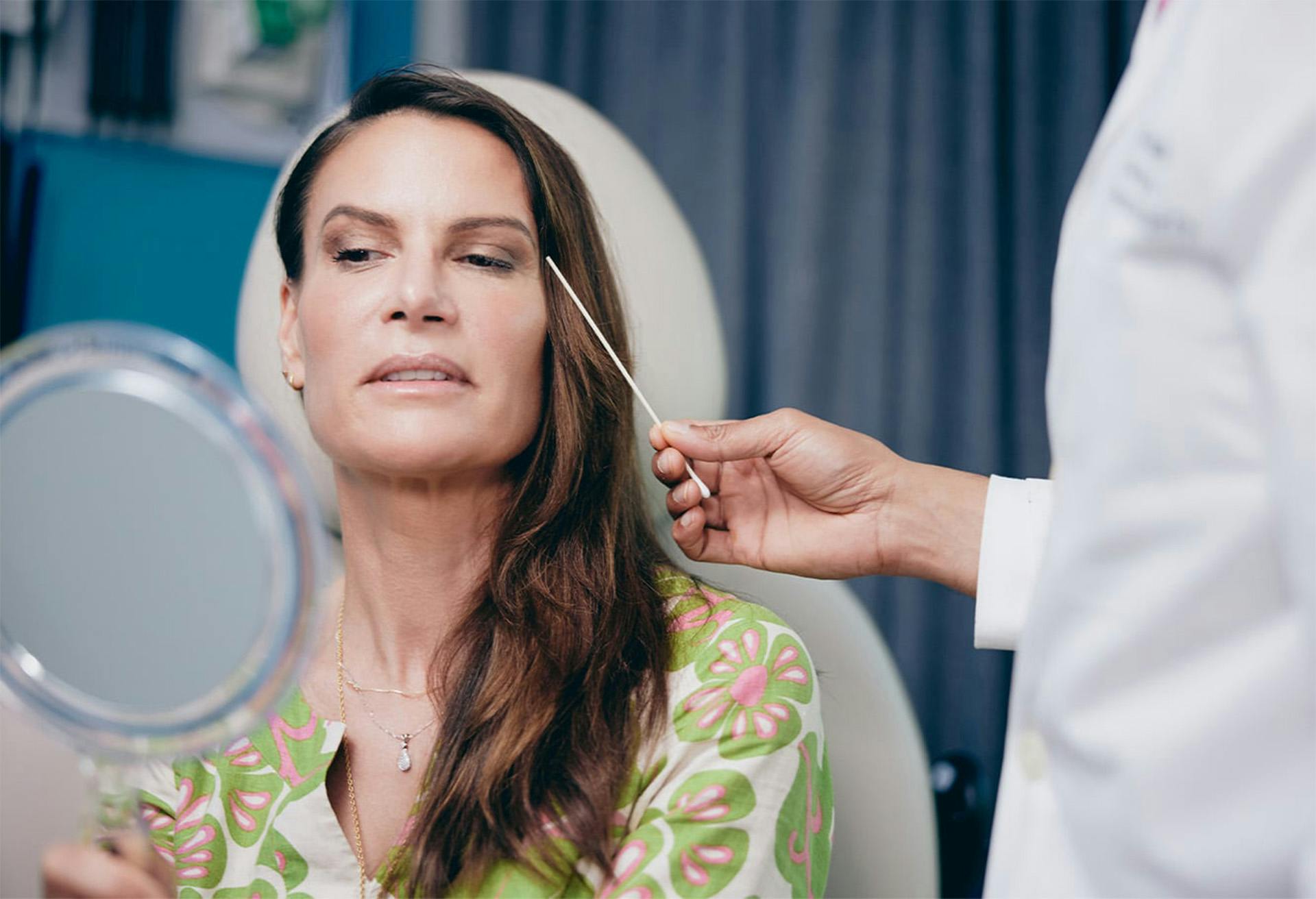 Woman Looking at Her Face in the Mirror