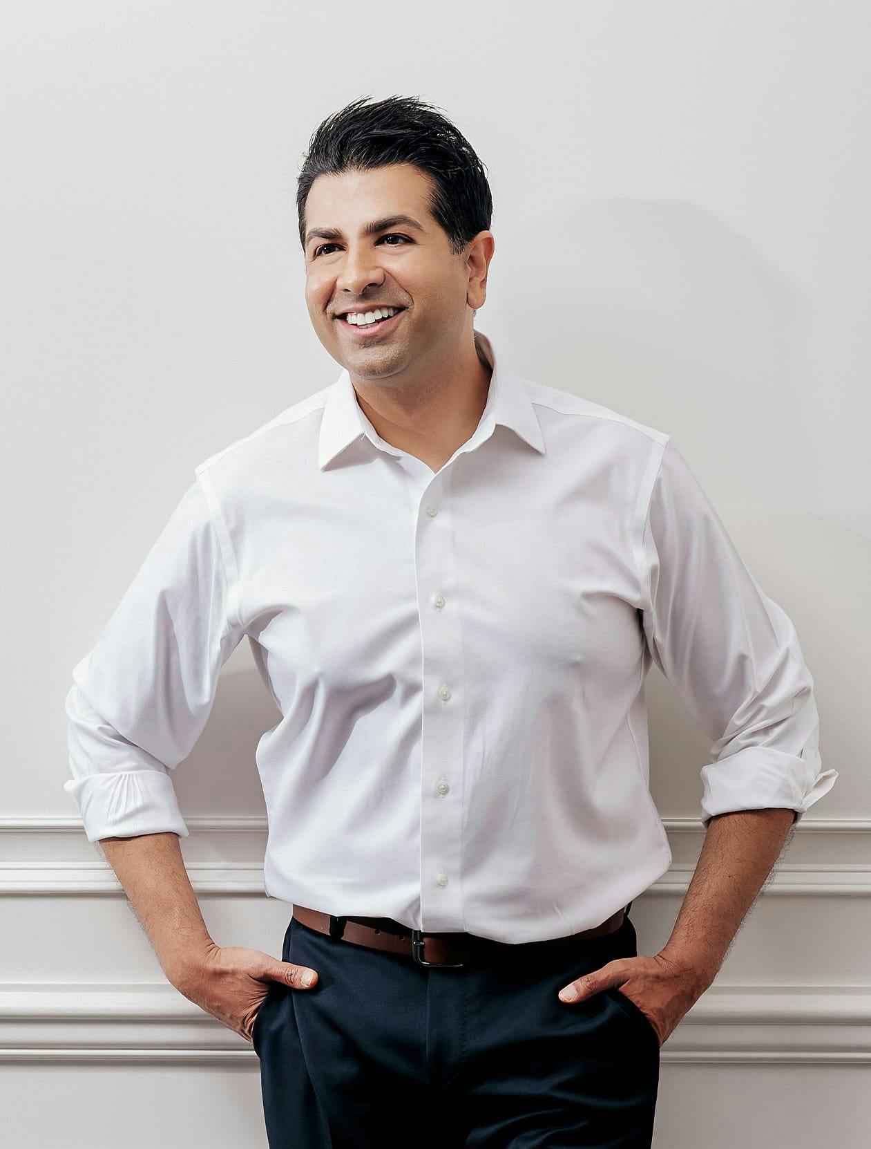 Dr. Neil Tanna in a white button up shirt