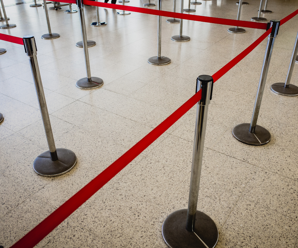 What is a Queue Barrier System?  Queue barriers can help you direct visitors into an orderly queue or enclosed when needed. They are often used in shops, restaurants, cafés and at various events – with indoor and outdoor versions available. What other names are there for queue barriers? • Queue Management Systems • Retractable Queue Barriers • Display Barriers • Crowd Control Barriers • Queue Rails • Post & Rope Barriers#top  Why use queue barriers?  Queue barriers are seen in a huge variety of locations – from red carpet award ceremonies to building sites. But why are they so popular and what are their primary uses? Control Visitor Flow & Keep Them Safe  Knowing where to queue is not always as straightforward for customers as you might think, so a queue barrier can help them navigate the store more easily. If you want to alert visitors to a hazard on your premises – such as wet floors or an area undergoing maintenance work – a highly-visible safety queue barrierhttps://www.displaywizard.co.uk/queue-barriers/safetymaster-high-visibility-retractable-barriers/  is a great way to cordon off dangerous areas. Create Privacy  Whether to create a VIP area in a nightclub or an outdoor dining area in a café, a queue barrier can also be used to create privacy for customers in your establishment. Café barriershttps://www.displaywizard.co.uk/cafe-barriers/  are always popular for creating privacy in pubs, restaurants and cafes. These display systems combine printed banners with queue barrier rails for added branding and privacy for customers. Add Cross-Sell Opportunities  The queueing area within a retail space is a great opportunity to cross-sell to the customer – usually with lower-cost ‘impulse’ buys like snacks or accessories. With many queue systems there are opportunities to add racking or display bowlshttps://www.displaywizard.co.uk/queue-barrier-display-bowl/  to promote certain products to passers-by and increase the order value for your store.#top  Types of Queue Barrier  Cafe Barriershttps://www.displaywizard.co.uk/cafe-barriers/   Café barriershttps://www.displaywizard.co.uk/cafe-barriers/  are a popular means of segmenting customer areas in cafés, restaurants, pubs and other establishments. They provide shelter from the wind and also display a printed message such as your company logo. They have heavy-duty bases with clip-on graphics that can be replaced for different seasons or certain promotions. Advantages  Branded displays Different configurations available Weatherproof  Retractable Belt Barriershttps://www.displaywizard.co.uk/retractable-belt-barriers/     Retractable belt barriershttps://www.displaywizard.co.uk/retractable-belt-barriers/  feature a discreet belt which pulls back into the housing on the post. These are the most popular type of queue barrier because they are easy-to-assemble and allow you to create multiple configurations with ease thanks to the 4-way receiver clips in the posts. They come in a variety of types from a standard indoor version including wall-mountedhttps://www.displaywizard.co.uk/retractable-belt-barriers/wallmaster-wall-mounted-retracting-barrier/ , free-standing,https://www.displaywizard.co.uk/retractable-belt-barriers/queuemaster-retractable-barriers/  twin-belthttps://www.displaywizard.co.uk/retractable-belt-barriers/queuemaster-twin-retractable-barriers/ , floor-fixedhttps://www.displaywizard.co.uk/queue-barriers/queuepro-floor-fixed-belt-barrier/ , highly visiblehttps://www.displaywizard.co.uk/queue-barriers/safetymaster-high-visibility-retractable-barriers/  and outdoorhttps://www.displaywizard.co.uk/queue-barriers/weathermaster-outdoor-retractable-safety-barriers/  versions. Another advantage of this type of queue system is the ability to display a printed message on the barrier itself. This can be a stock message such as ‘DO NOT ENTER’ OR ‘NO PARKING’ or a custom-printed messagehttps://www.displaywizard.co.uk/retractable-belt-barriers/queuemaster-custom-barriers/  or logo on larger orders. Advantages  Simple Mechanism Highly Customisable Can display printed message  Post & Rope Barriershttps://www.displaywizard.co.uk/post-and-rope-barriers/   Post and rope queue barriershttps://www.displaywizard.co.uk/post-and-rope-barriers/  are a high-quality queue solution popular with nightclubs, cinemas and premium events. The ropes come in a variety of colours, with the stanchions also available in a range of finishes. These barriers use a simple hook fastening attaching the rope to the stanchion, great for managing entry to premises. Using a wall platehttps://www.displaywizard.co.uk/ropemaster-wall-plate/ , the ropes can even be attached directly to a wall fixing. Advantages  Premium design Range of post tops available Simple to assemble#top   What to look for in a queue barrier system?  There are many different features you need to know about when searching for a queue barrier system, with a wide variety of quality and functionality which can make or break your purchase. Here are three of the most important things to look out for: Belt Length  When buying a queue barrier, belt length is one of the most important factors. Some queue barriers come with extra-long belts, which lessens the number of posts you require. Look out for queue barrier systems with belt lengths over 3mhttps://www.displaywizard.co.uk/queue-barriers/queuemaster-retractable-barriers/  for added value. The industry standard is 2.3m. Base Weight  Queue systems can be knocked easily by customers so it’s important they have a heavy base in order to remain in place.This is especially important for outdoor barriers, which can be blown around by the wind if they’re lightweight. Connections & Release Mechanism  Ideally you need a 4-way connection on the post to create a range of different configurations as needed.It is also beneficial if the systems feature a slow-retract braking system, meaning the belts retract slowly rather than snap shut, potentially causing damage to the belt end.#top  Ideal Uses of Queue Systems  Queue barrier systems are seen in a wide variety of locations, here are some of the most popular uses: • Queue system in retail stores • Christmas markets • Cinema queues • Nightclub queues • Museum management • Christmas fairs • Building Site Management • Airport queues • Smoking area outside pub, nightclub, restaurant or cafe • Many, many more…#top  Which supplier should I choose for my queue barriers?  With over fifteen years providing display equipment for a range of different industries, Display Wizard are experts in all manner of display stands. • Products kept in-stock for quick UK despatch • Hardware Guarantees • Custom Belt Printing Available For all your queue barrierhttps://www.displaywizard.co.uk/queue-barriers/  enquiries please get in touchhttps://www.displaywizard.co.uk/contact-us  with Display Wizard today – we are always happy to help!