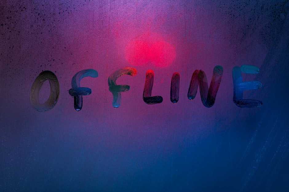 word offline handwrittern on foggy glass with cold neon blue back light