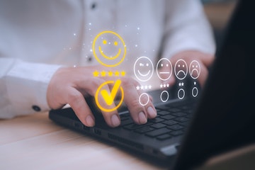 using computer laptop with popup five star icon for feedback review