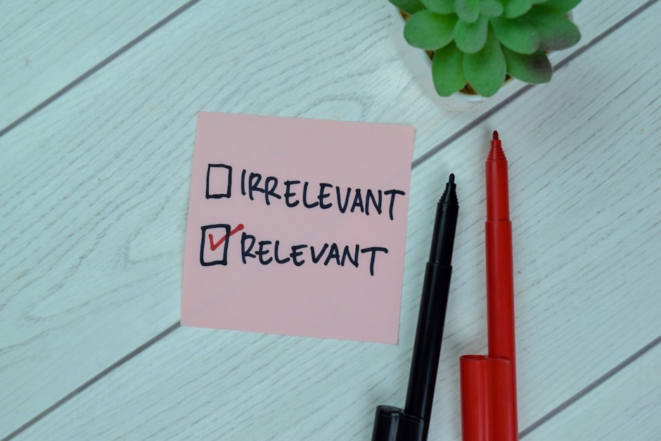 words irrelevant and relevant with checkbox written on a pink sticky note