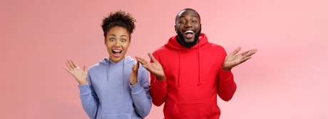 man and woman wearing hoodie with a surprised look on their faces