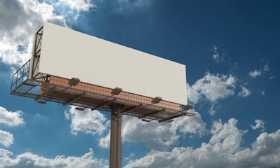 blank billboard with blue skies at the back
