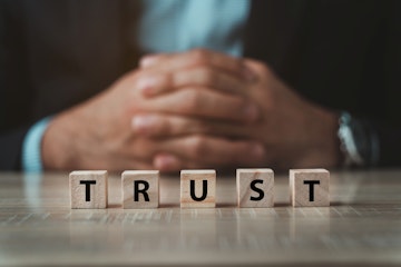 word trust spelled on small wooden blocks