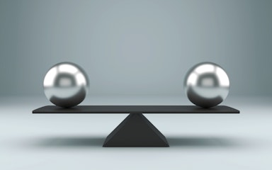 Equal spheres balancing on a seesaw