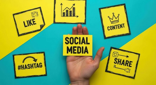 Hand Holding Social Media Card Surrounded by Like, Share, Content, and Hashtag on Colorful Background