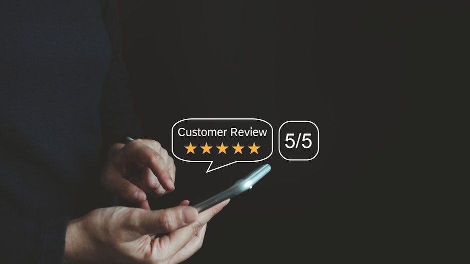 happy business customer using smartphone leaving positive review