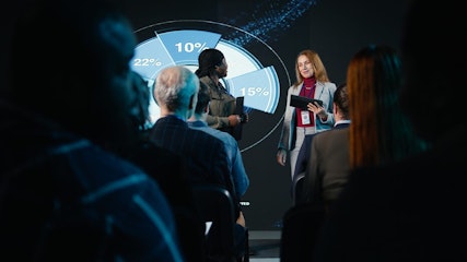 Diverse team of female presenters hosting a business conference at the international summit event