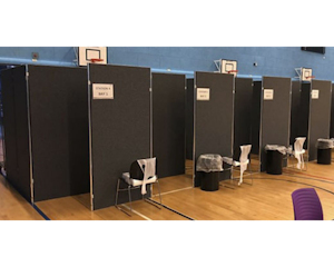 A row of Vaccination Pods in a sports hall
