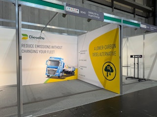 A Shell Scheme space with branding for Trucks and Lowe carbon emissions. The colours consist of white, yellow and green.
