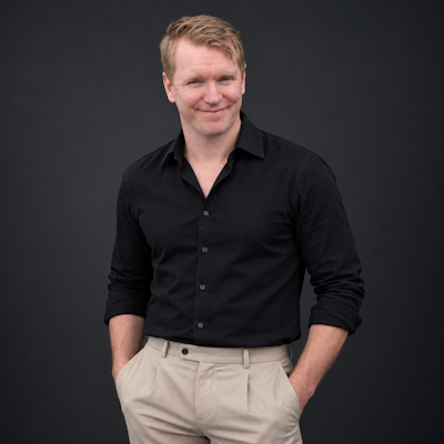 David Chyriwsky eCommerce Manager of Display Wizard, man wearing black shirt and cream pants