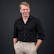David Chyriwsky eCommerce Manager of Display Wizard, man wearing black shirt and cream pants