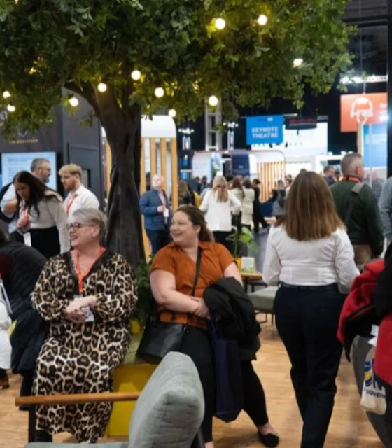 People walking around Highways UK exhibition hall.