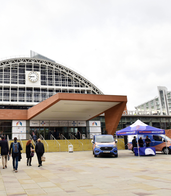 An exterior shot of Manchester Central Convention, with the banner promoting the Healthcare Estates logo on it.