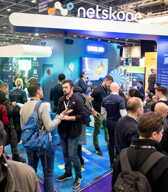 People stood in front of a stand at the Tech Show London.