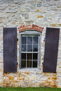 Recreated 1870 shop window showing a large glazed storefront and displayed goods