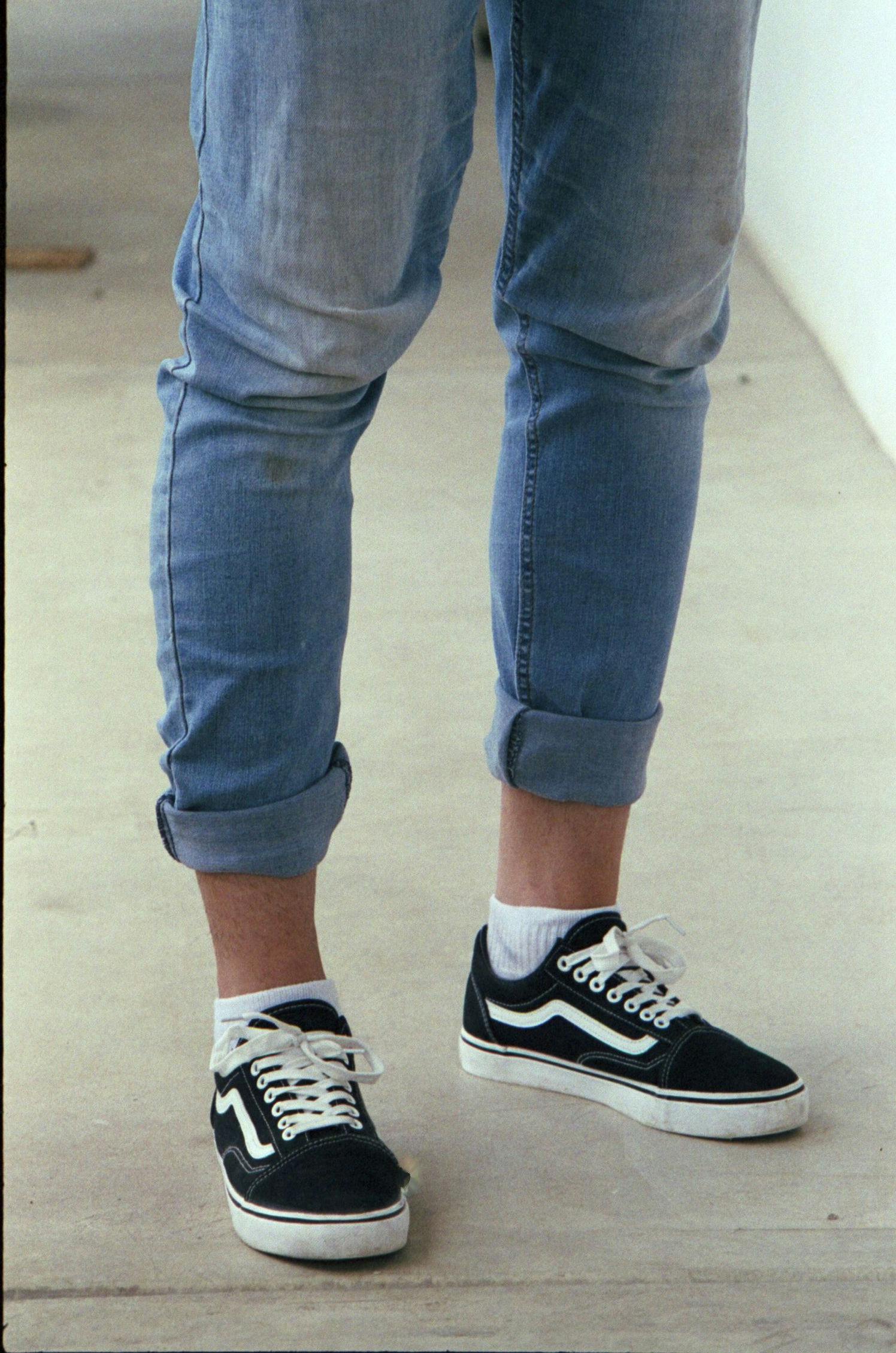 my brother in his jeans rolled up with Vans shoes