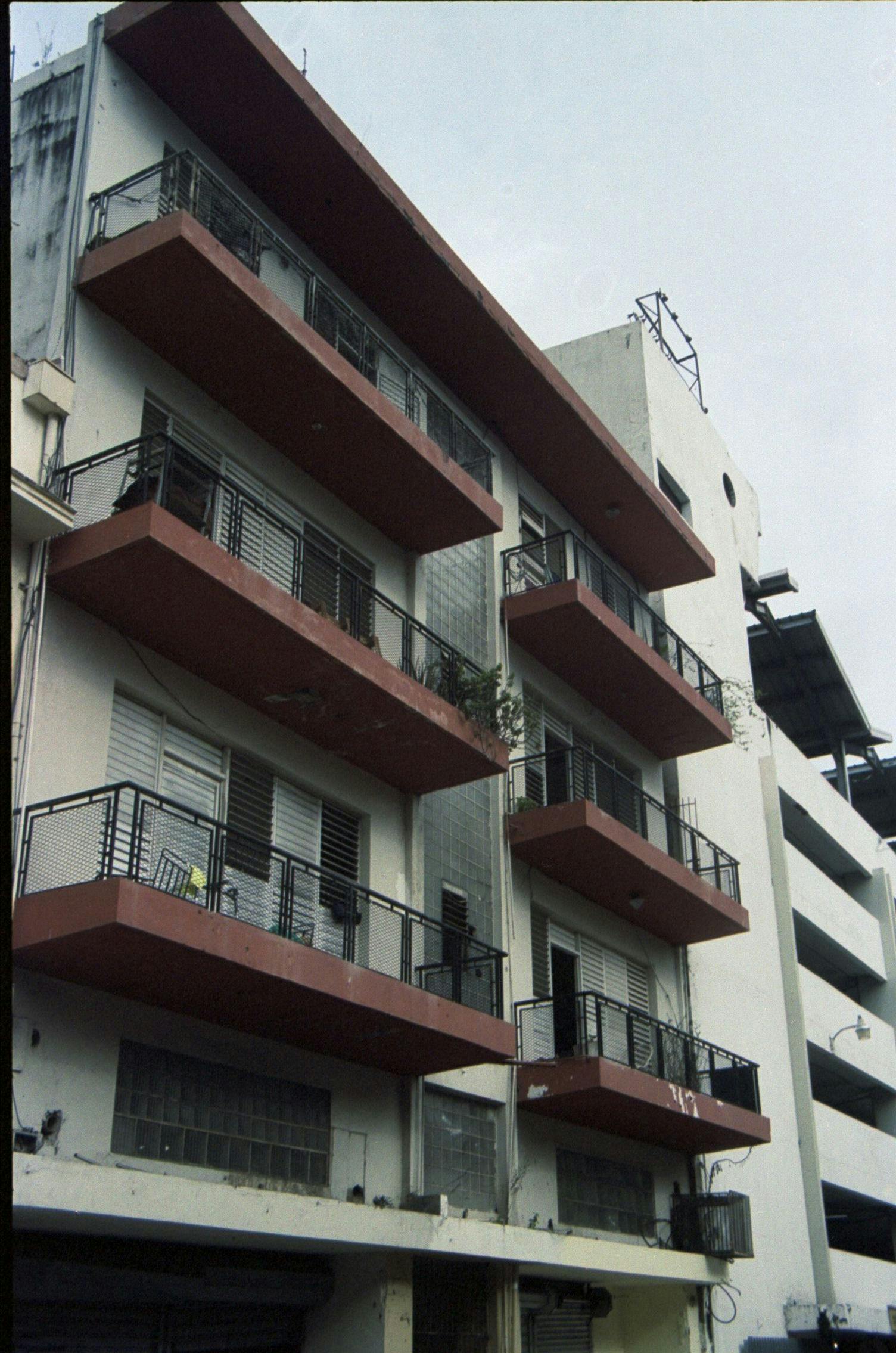 white building with red balconies
