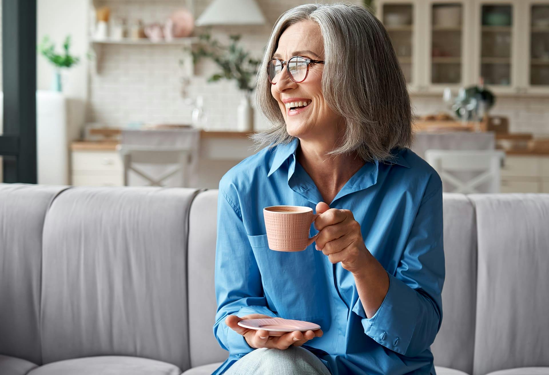 Woman enjoying coffee while sitting on a couch