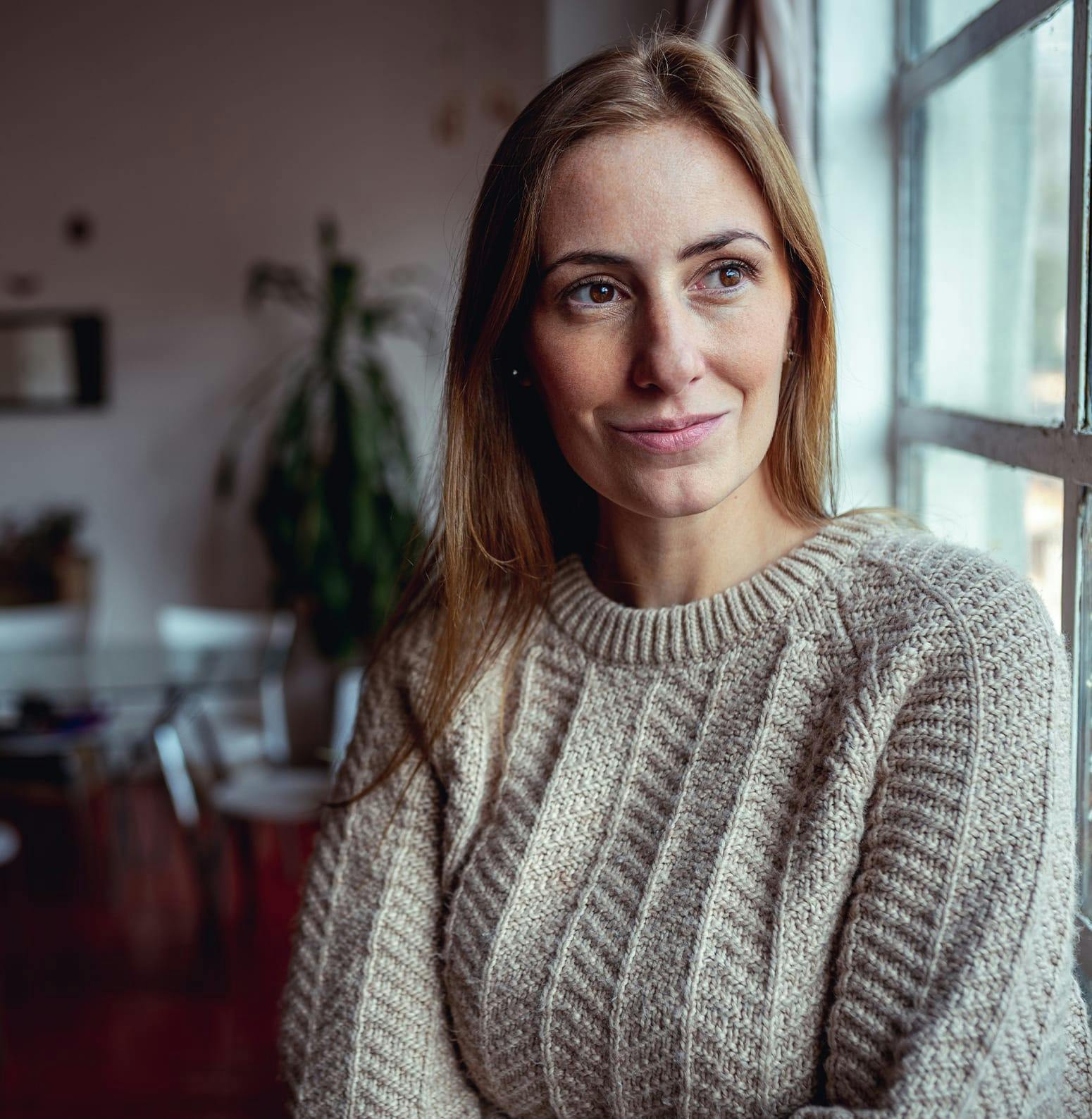 Woman in sweater smiling