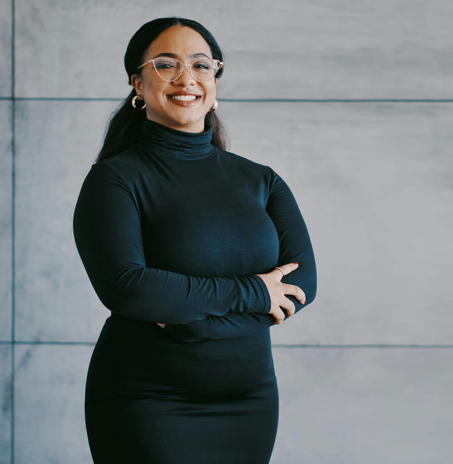 Woman in all black with her arms crossed