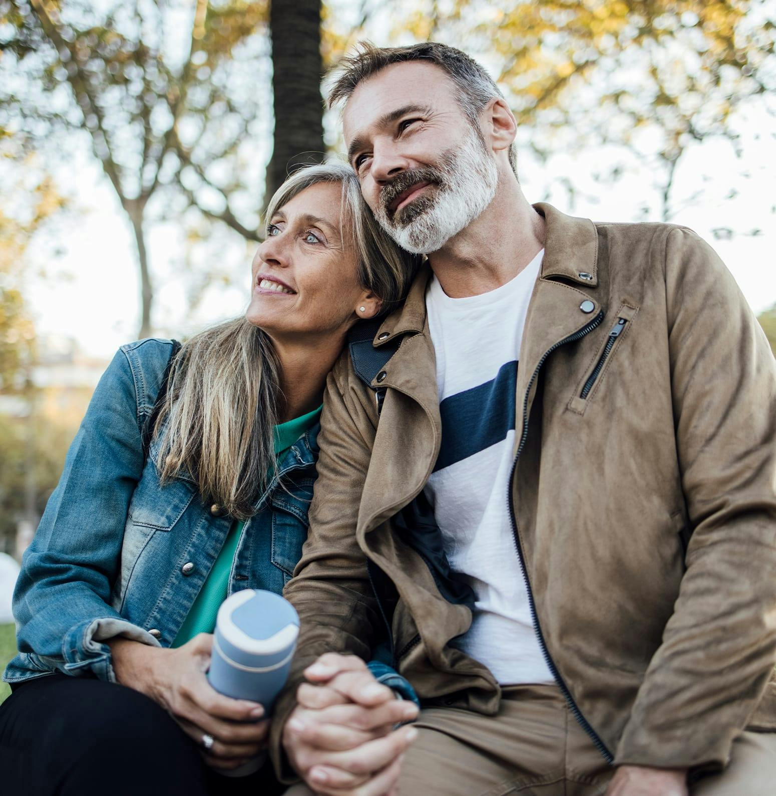 Woman and man nuzzling together outside