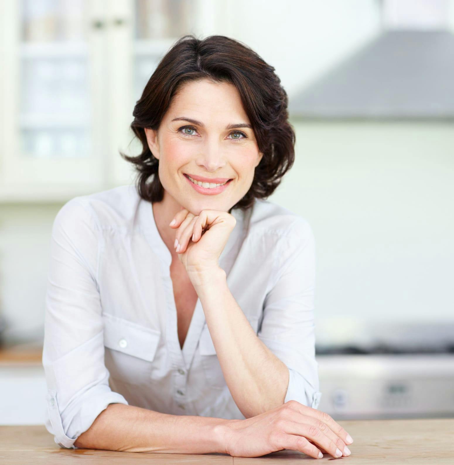 Woman smiling while resting on a counter