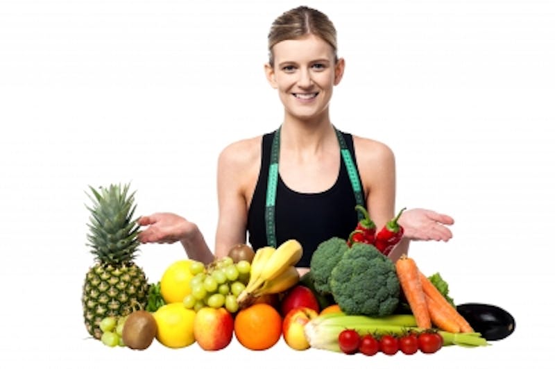 woman with a lot of fruits and vegetables on a table