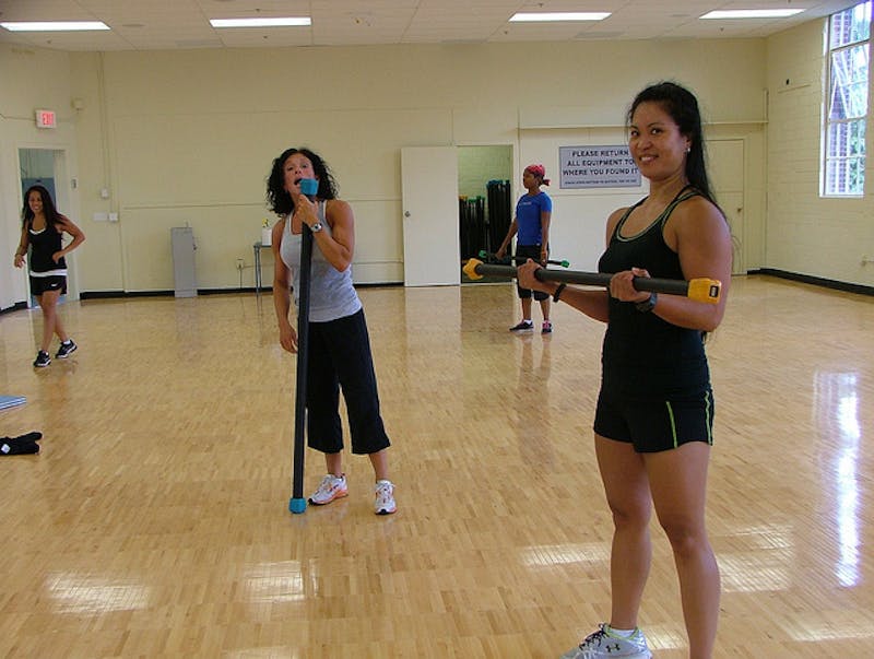 there are people in a gym with a wooden floor