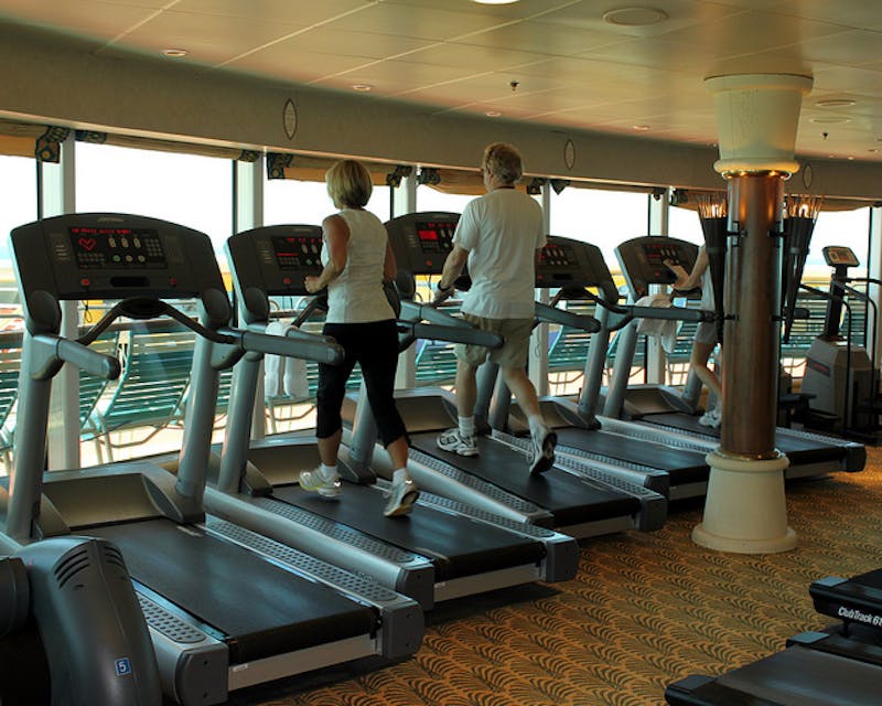 there are people on tread machines in a gym room