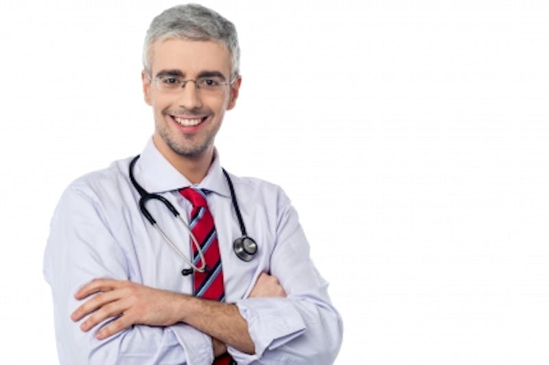 male doctor with stethoscope and red tie posing for a picture