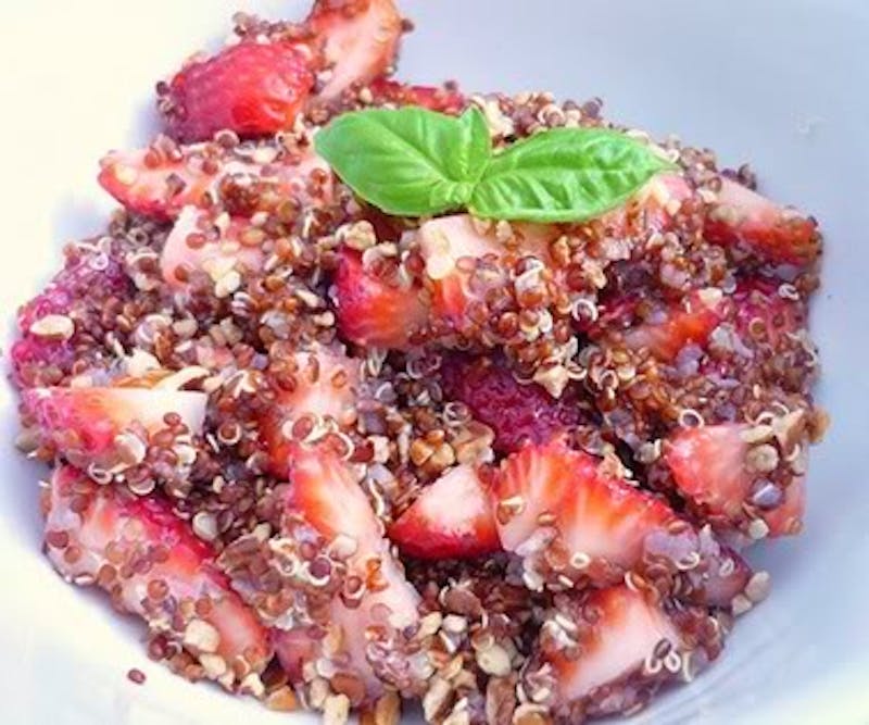 there is a bowl of food with strawberries and nuts on it