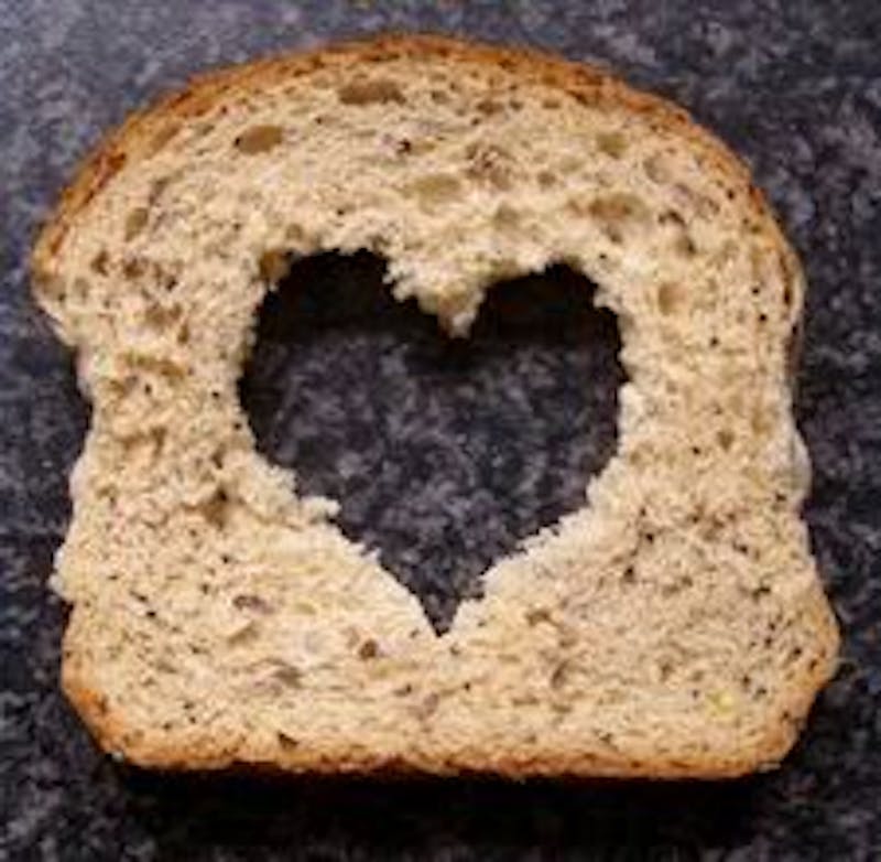 a close up of a piece of bread with a heart cut in it